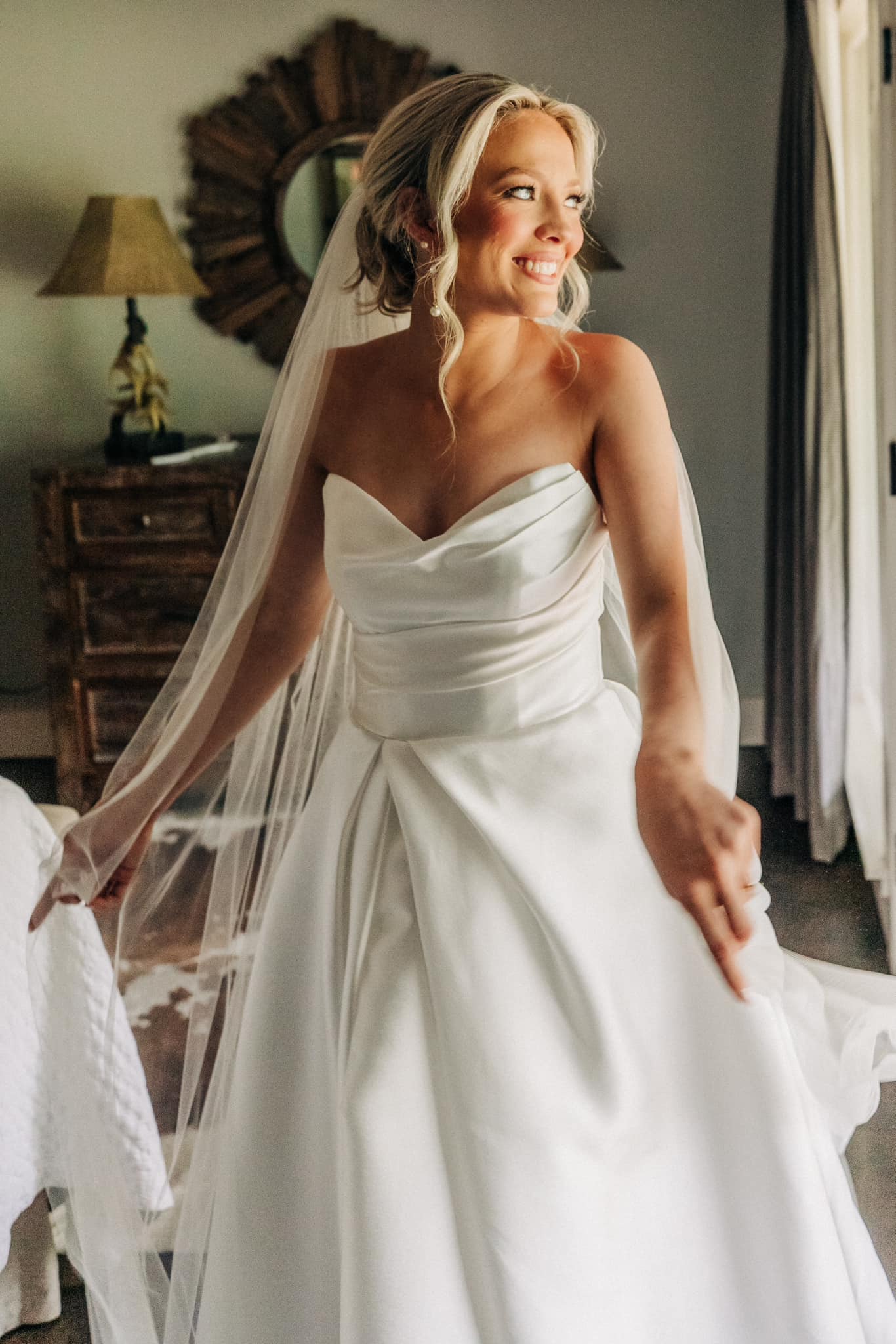 Bride getting ready in North Mississippi bridal suite with full-length mirrors at Brookwood Venue