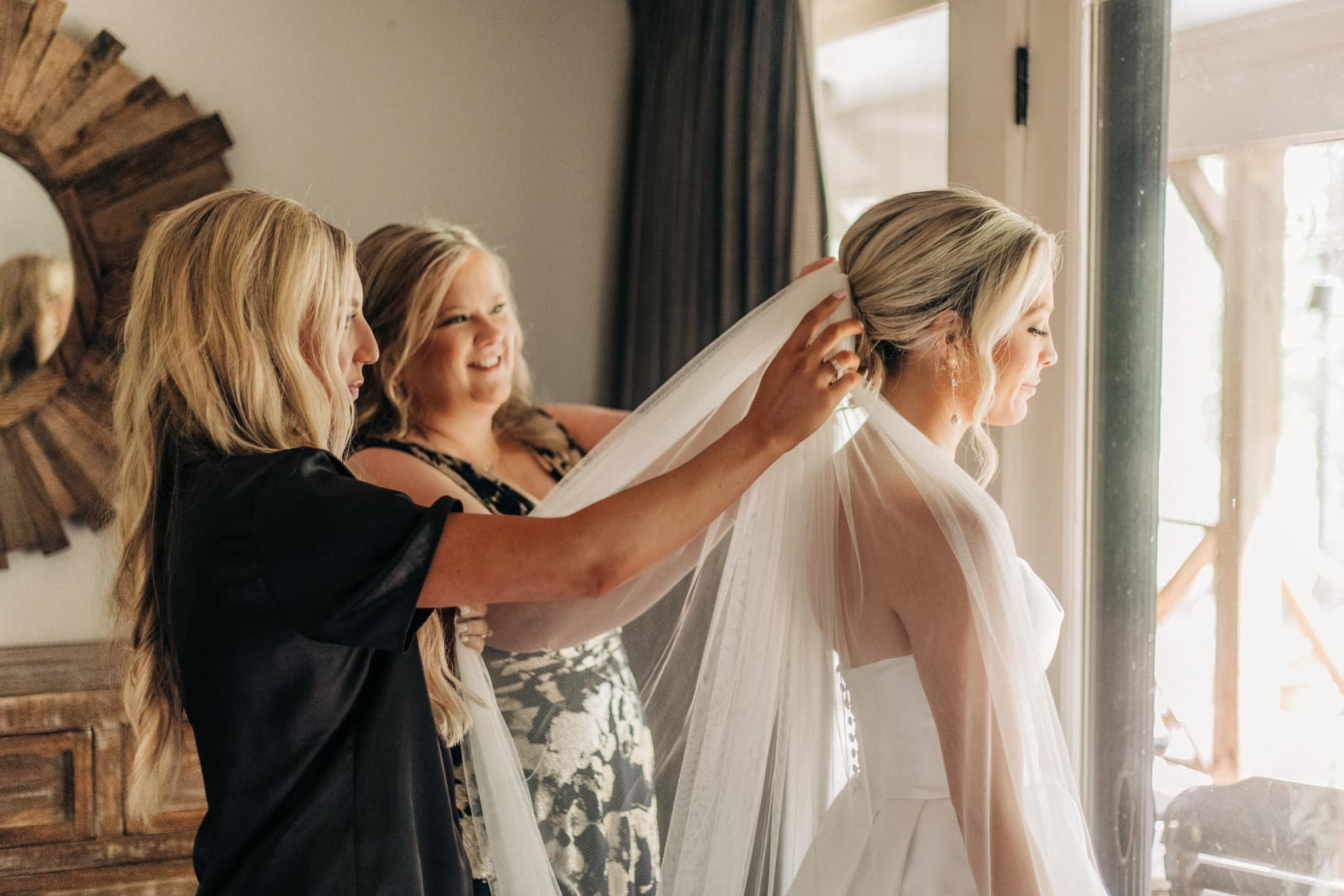Bridesmaids helping bride in luxurious Brookwood Venue bridal suite, Oxford, Mississippi