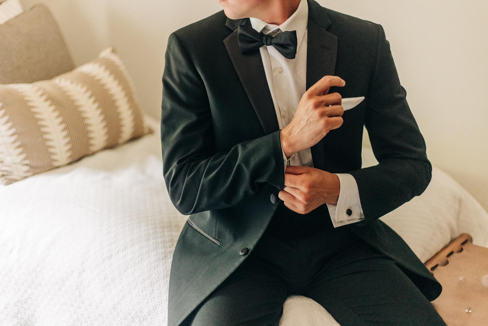 Groom checking shoes and accessories before ceremony in cabin at Brookwood Venue, North Mississippi."