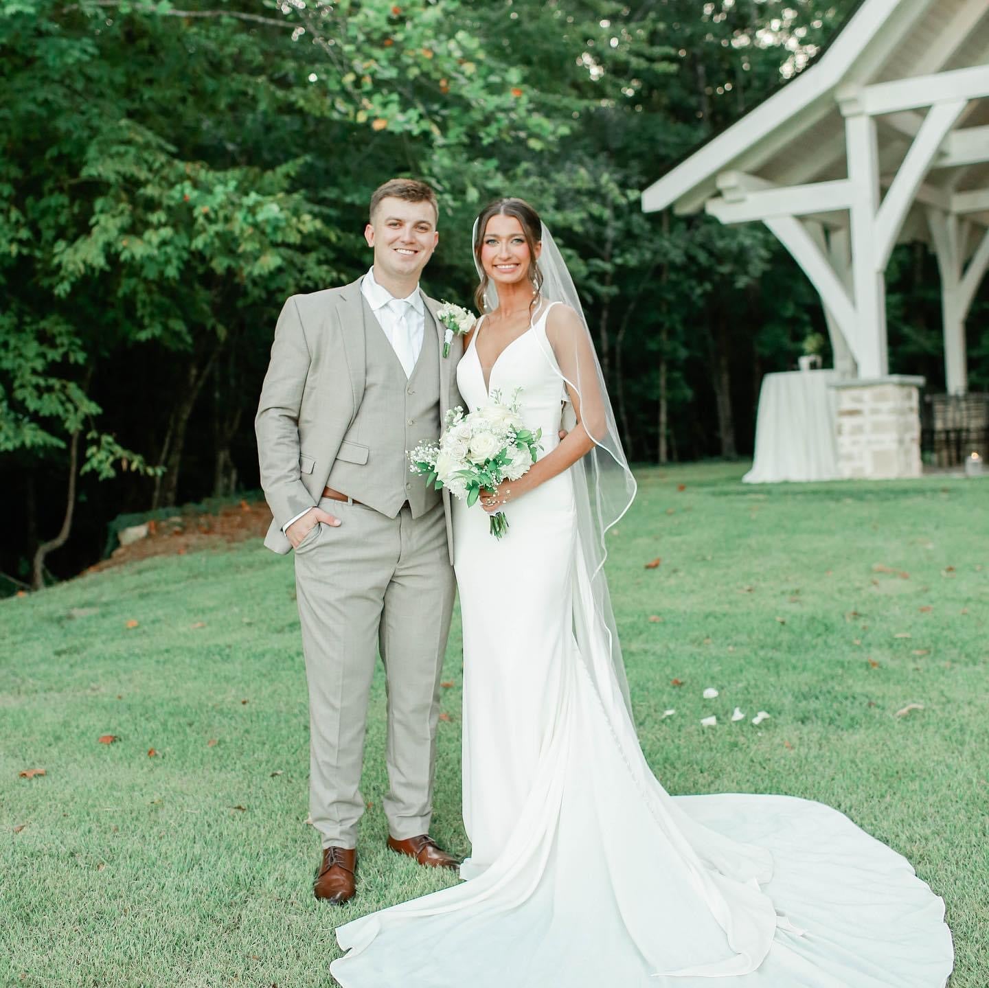 Newlyweds posing in front of chapel at Brookwood Venue in Bruce, Mississippi