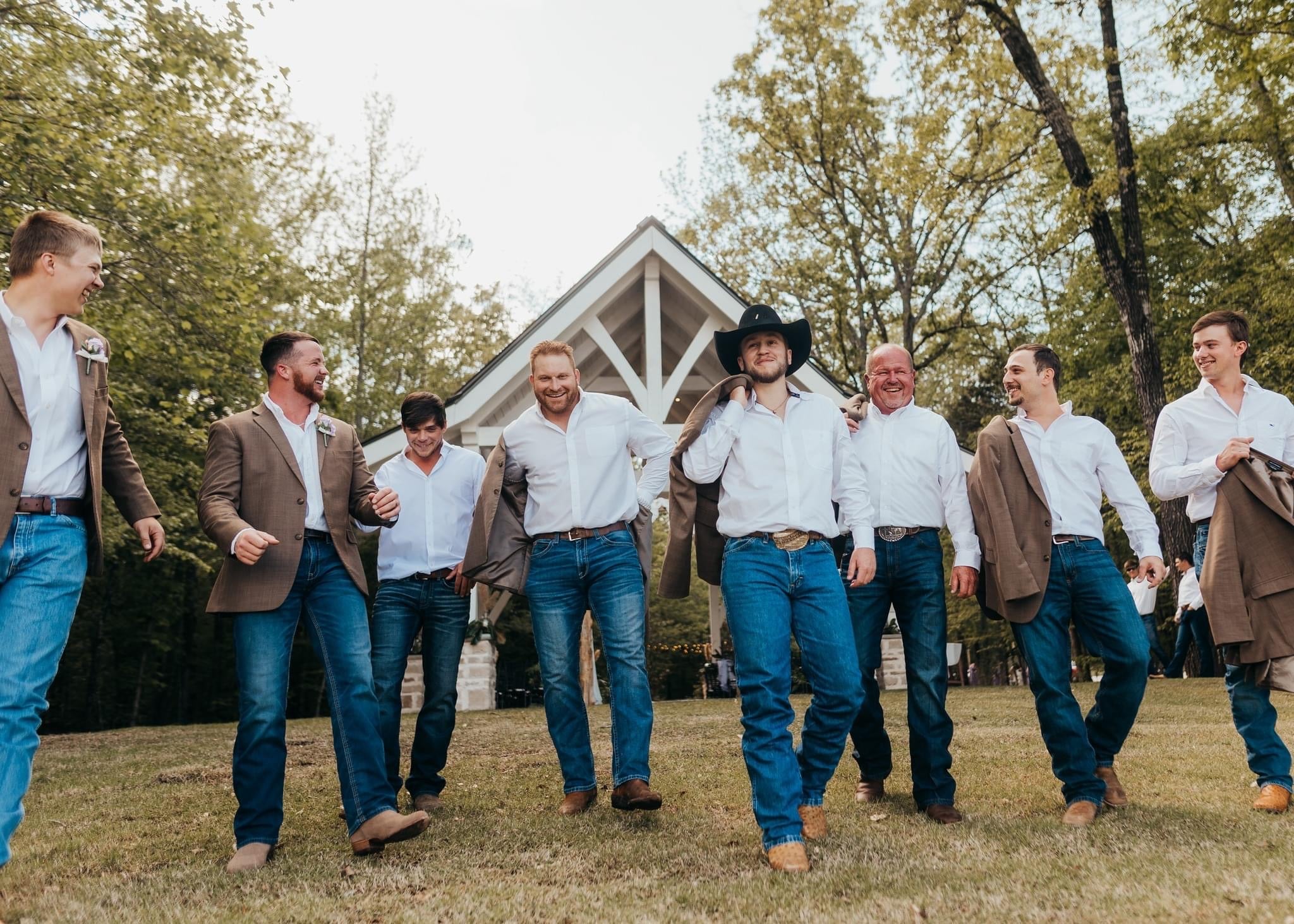Groom preparing with friends in cabin at Brookwood Venue in Bruce, Mississippi