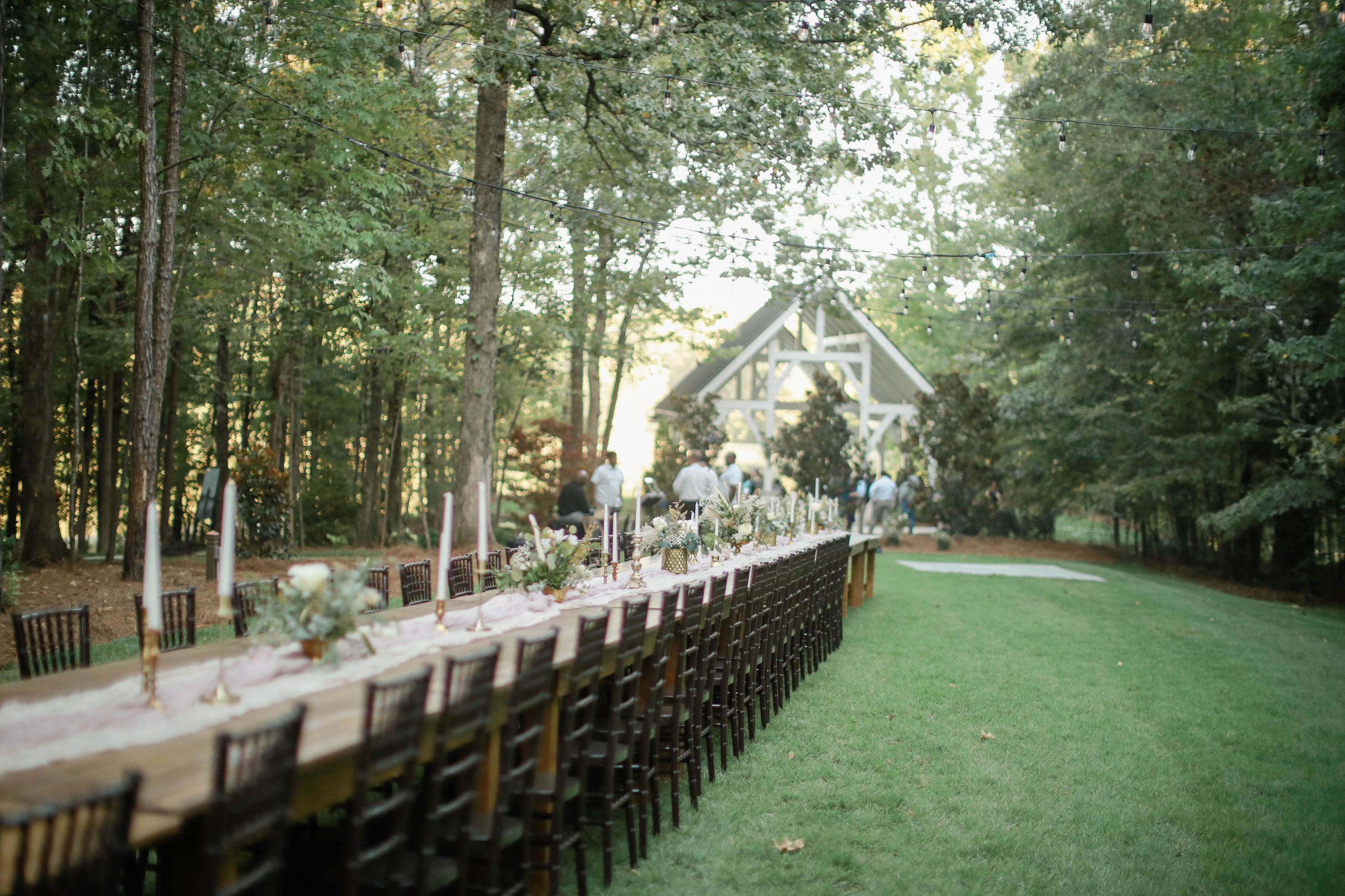 Wedding reception setup with long tables and candles at Brookwood Venue