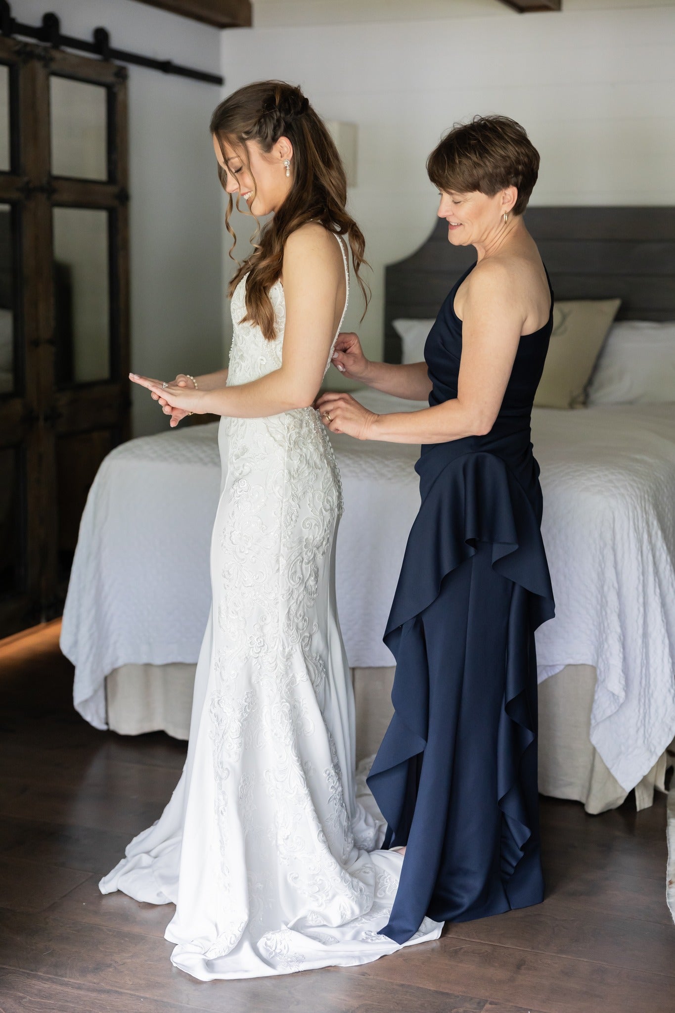 Mother of the bride adjusting daughter’s veil in Brookwood Venue cabin, Oxford, MS.