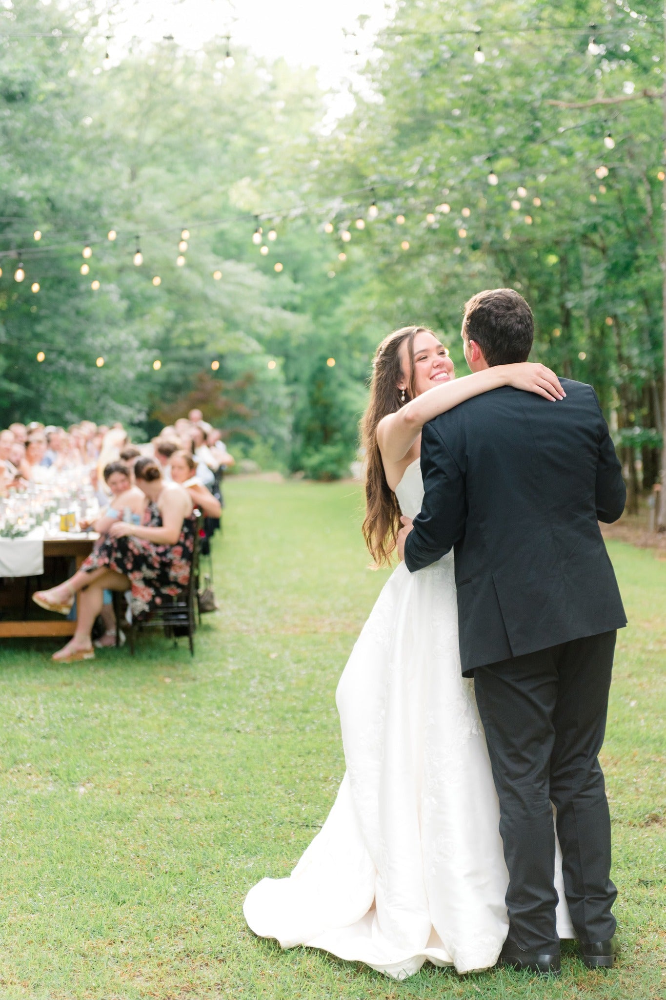 Bride and groom dancing together outdoors at Brookwood Venue in North Mississippi
