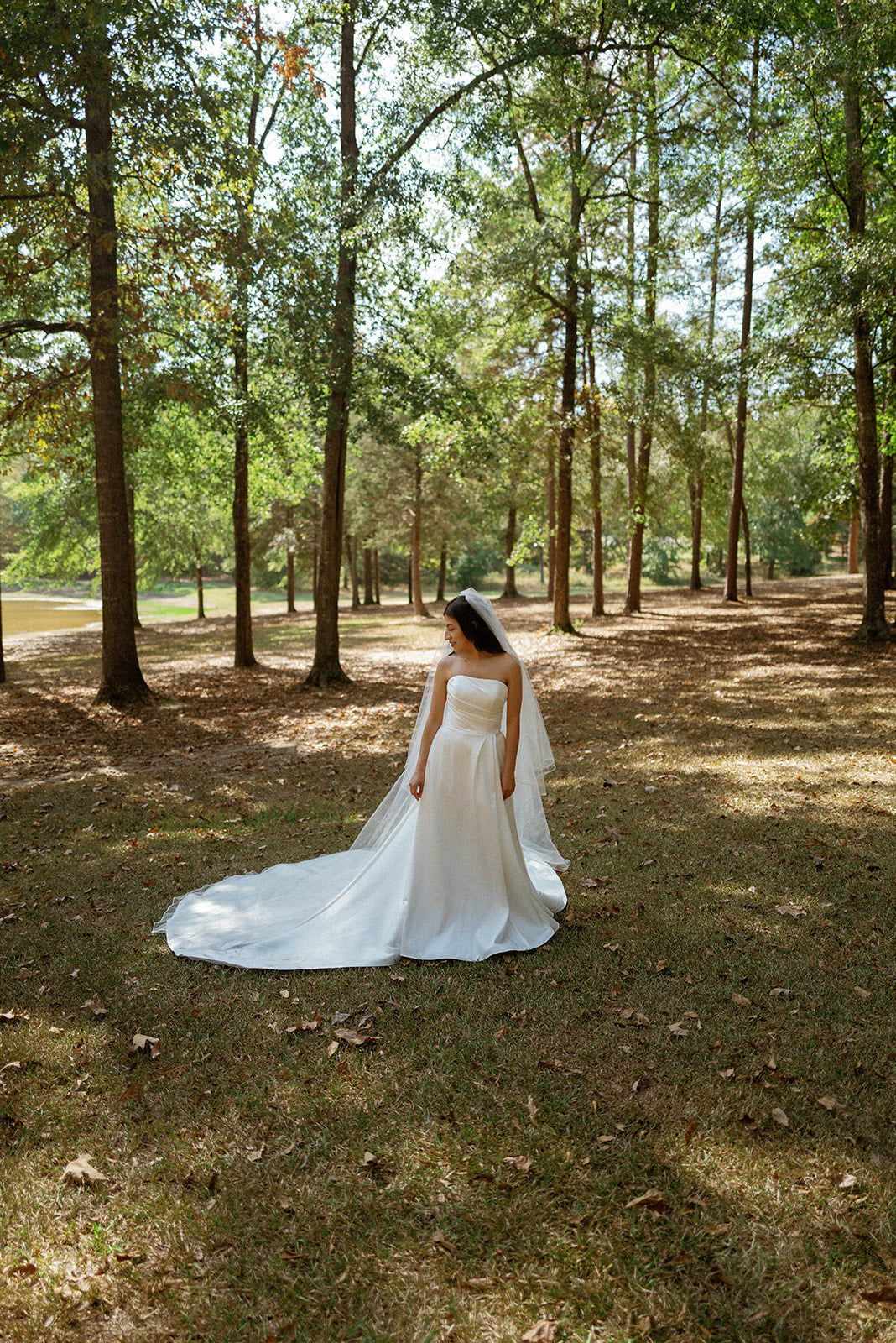 editorial and film bridal portraits in field by lake in tupelo, mississippi