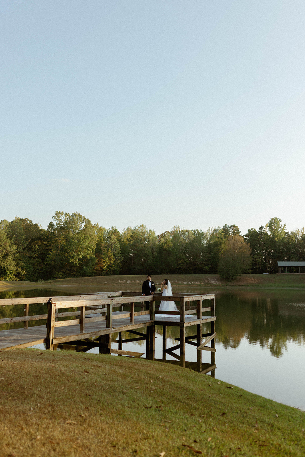 bride and groom wedding portraits at lakeside venue in oxford Mississippi