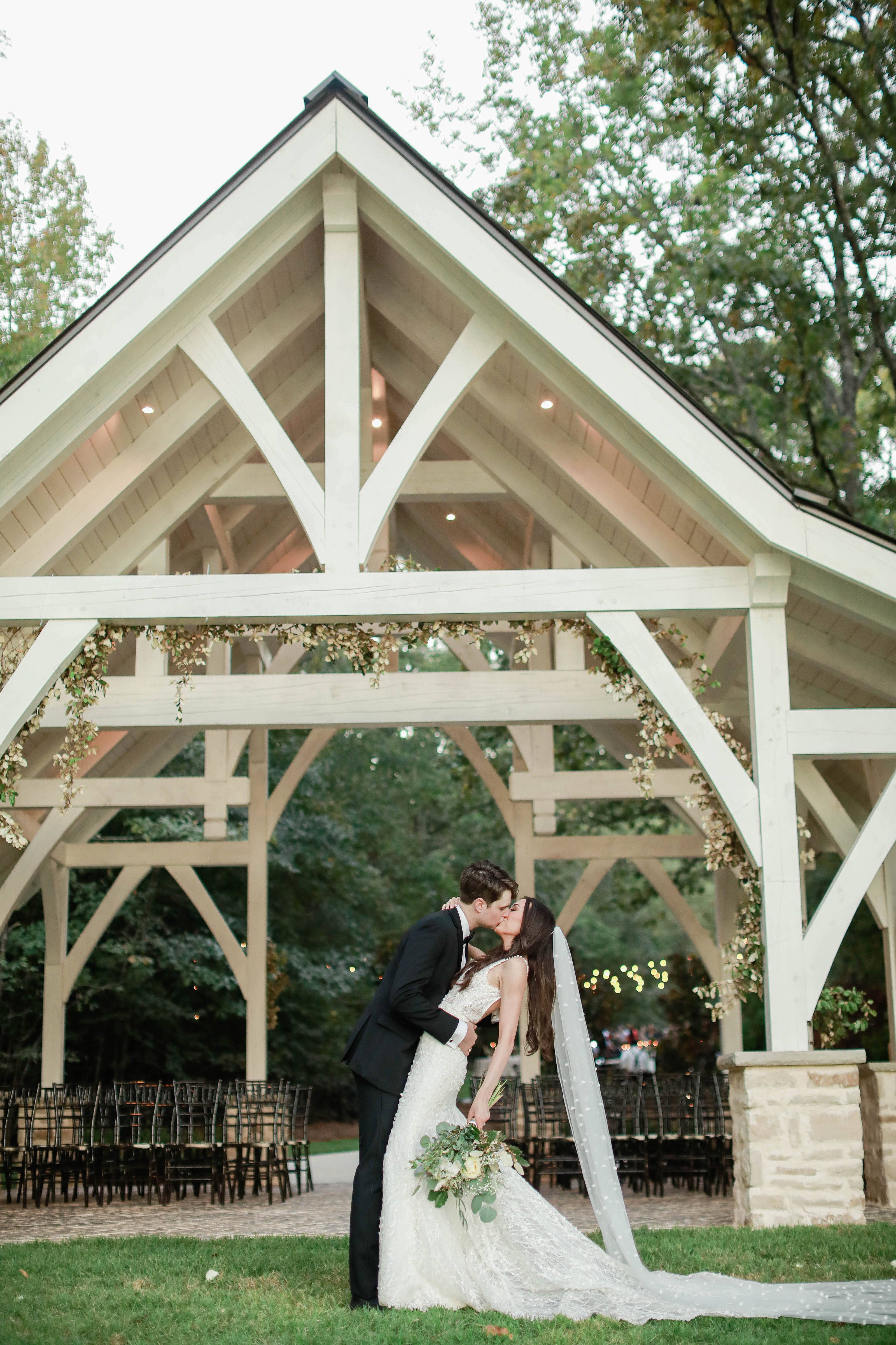 Bride and groom kissing by the chapel at Brookwood Venue near Oxford, Mississippi.