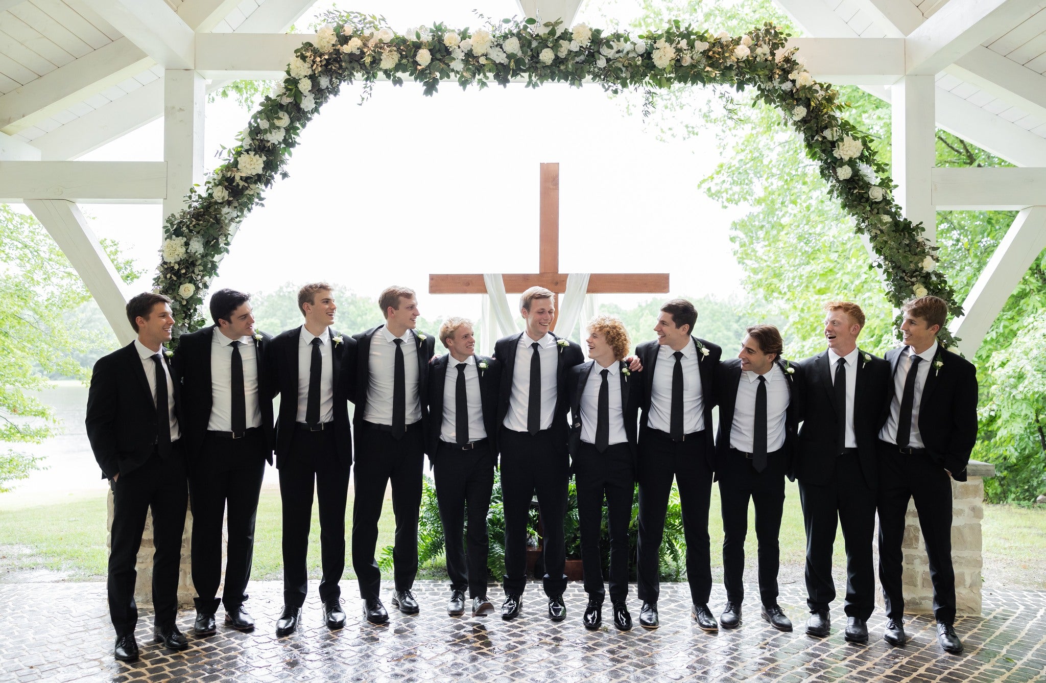 Groomsmen laughing together during wedding photos at Brookwood Venue near oxford