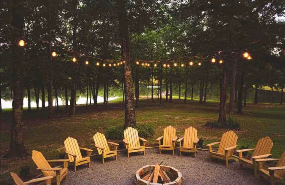 Outdoor seating and firepit at lakeside Airbnb rental near Oxford, Mississippi, perfect for relaxing evenings