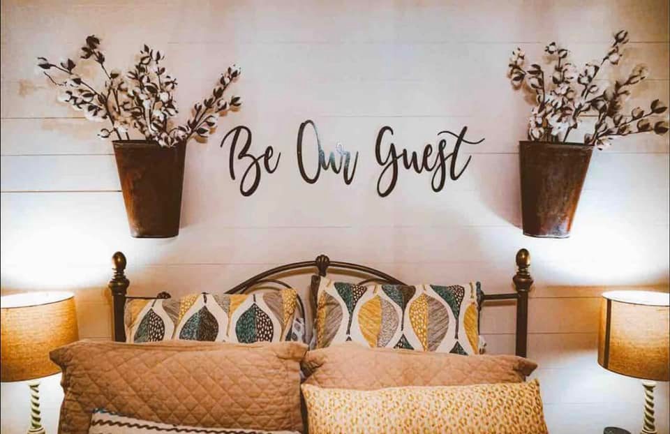 bedroom with large windows and lake view in lakeside Airbnb outside Oxford, Mississippi