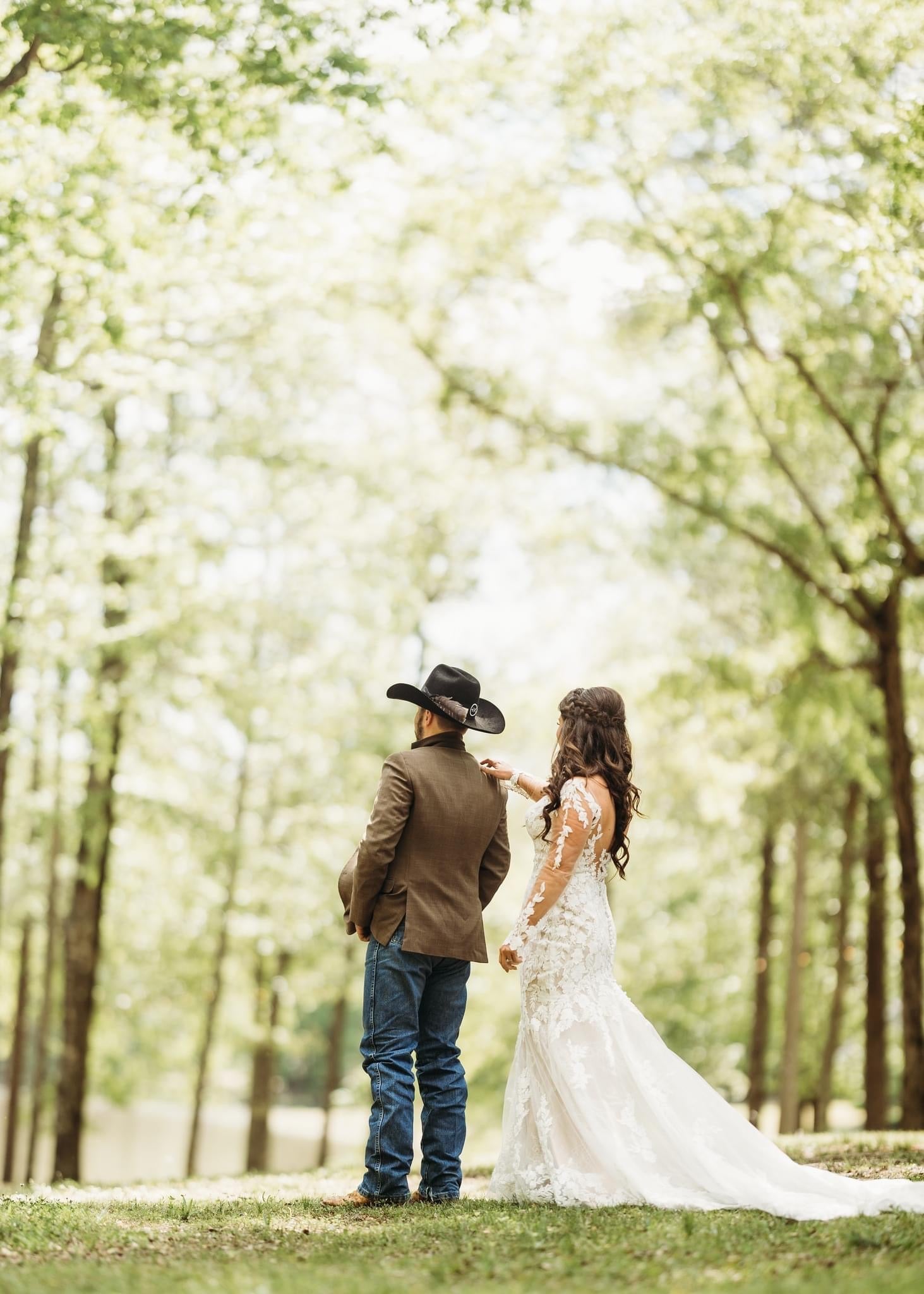 bride and groom walking through tall grass at Brookwood Venue countryside