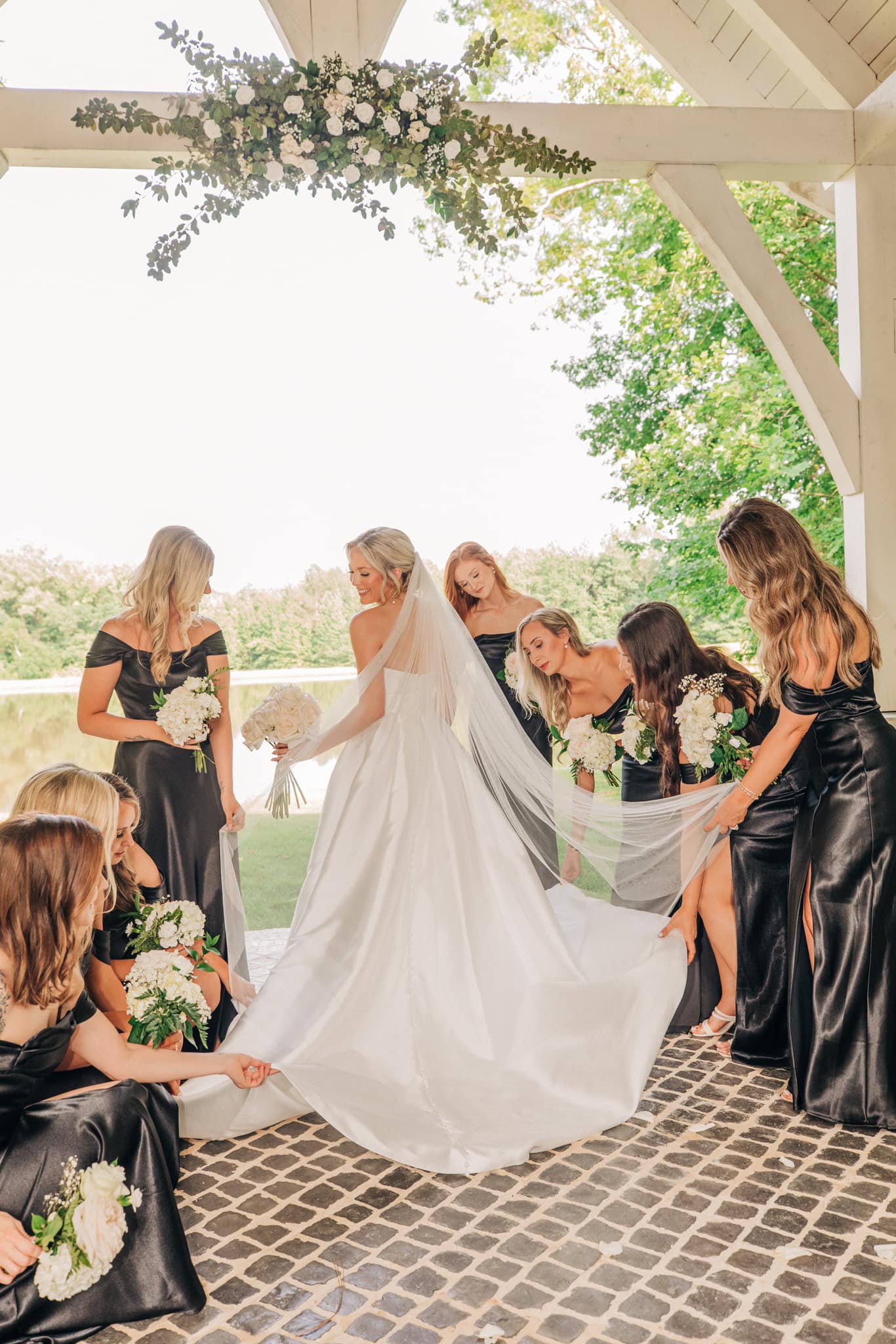 Bride posing with bridesmaids at Brookwood Venue near Oxford, Mississippi