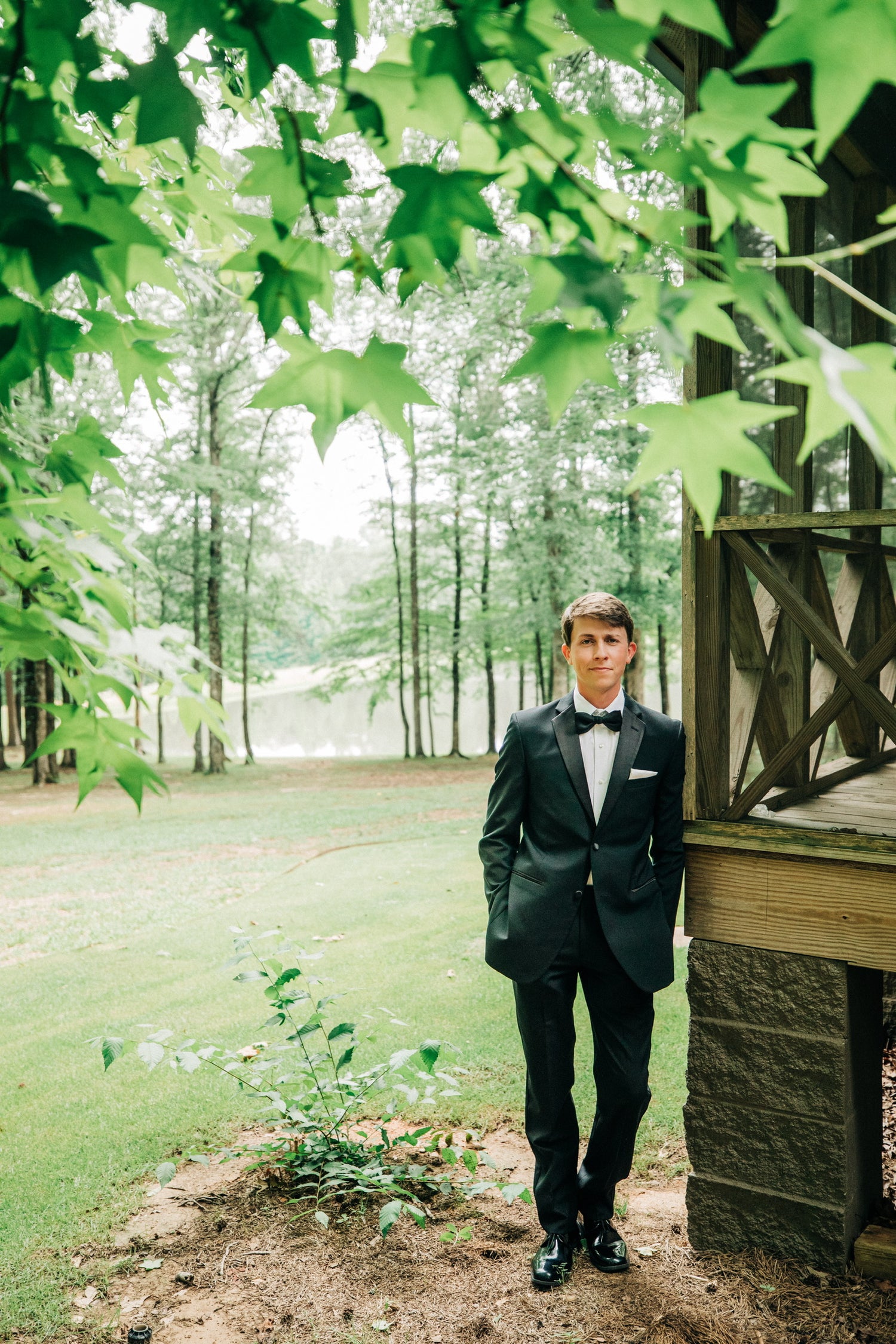 groom photos outside luxury airbnb cabin in north mississippi