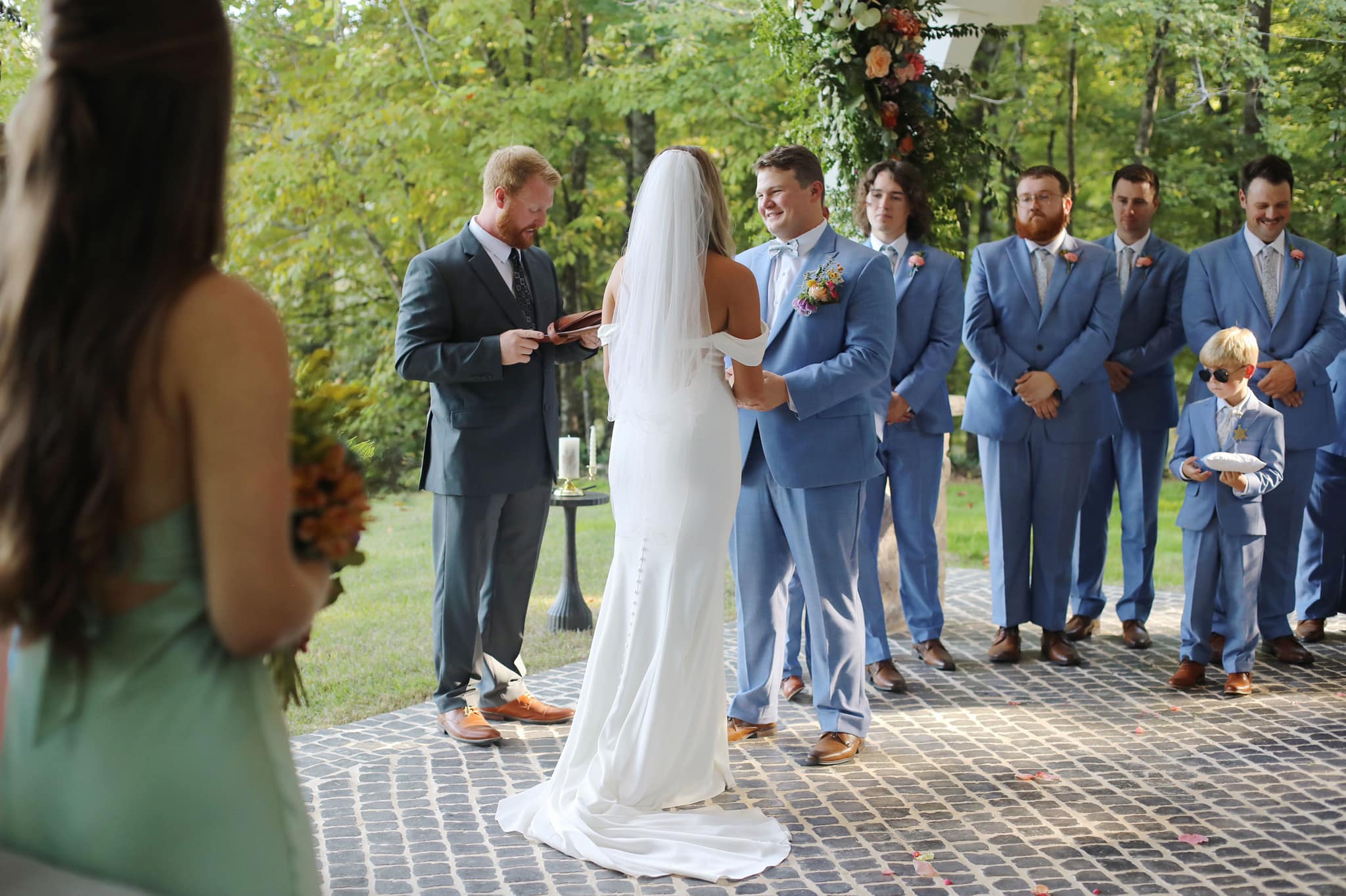 Bride and groom sharing a quiet moment under trees at North Mississippi wedding venue.