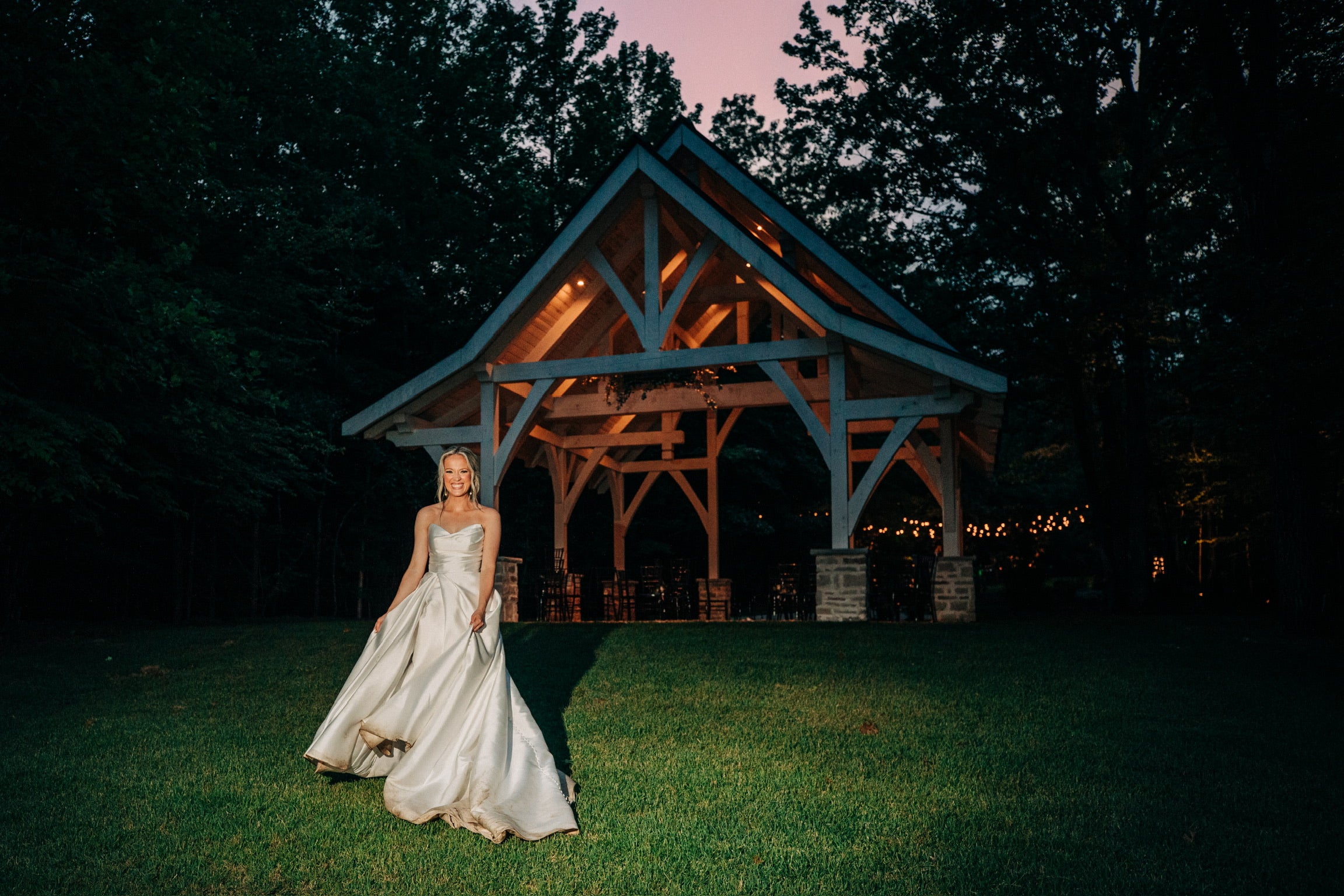bride twirling in her wedding dress outside of her wedding reception in north mississippi