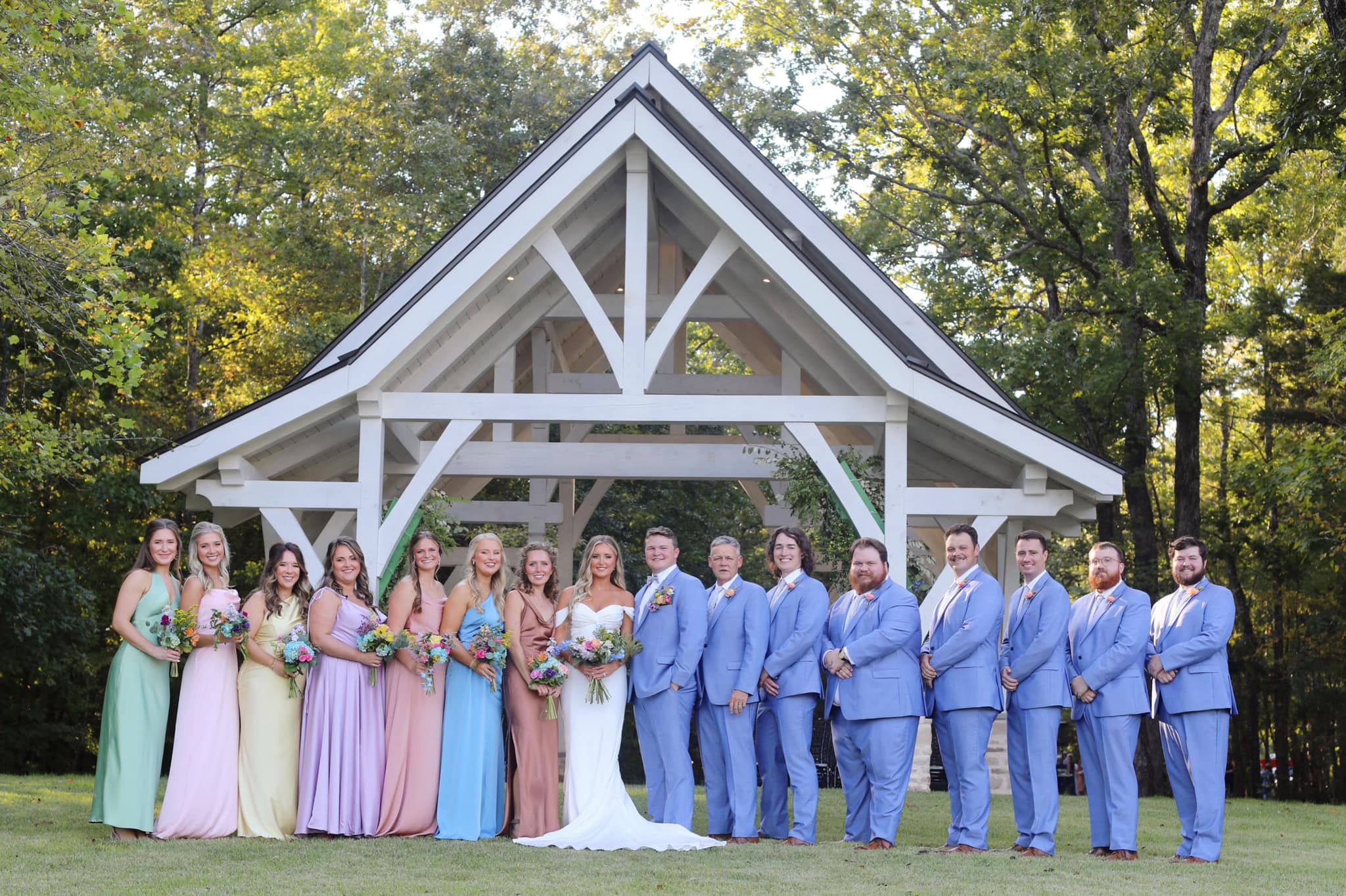 wedding party posing in front of the wedding chapel at Brookwood Venue in Bruce, MS