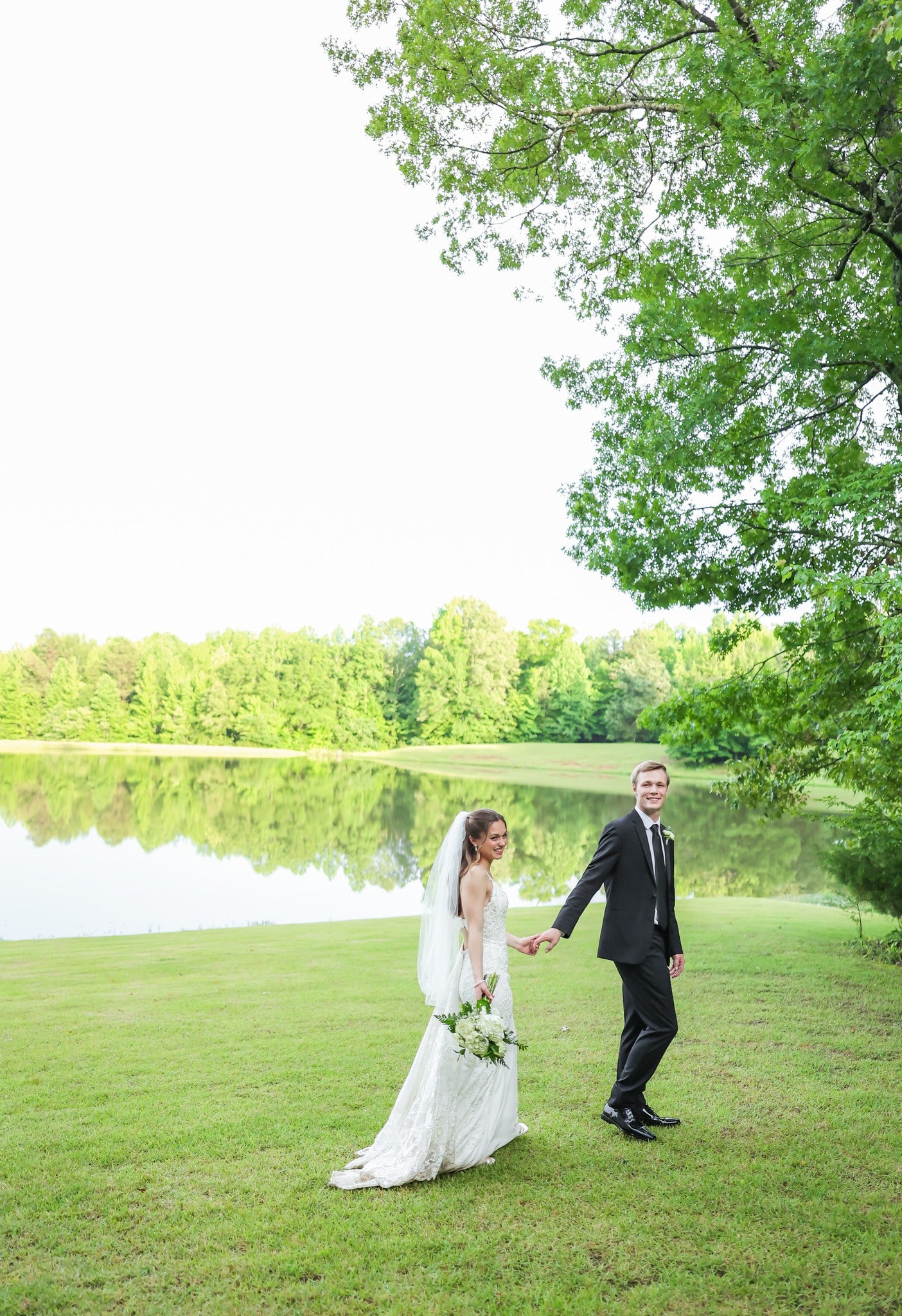 couple walking by lake on Brookwood Venue property outside Oxford, Mississippi