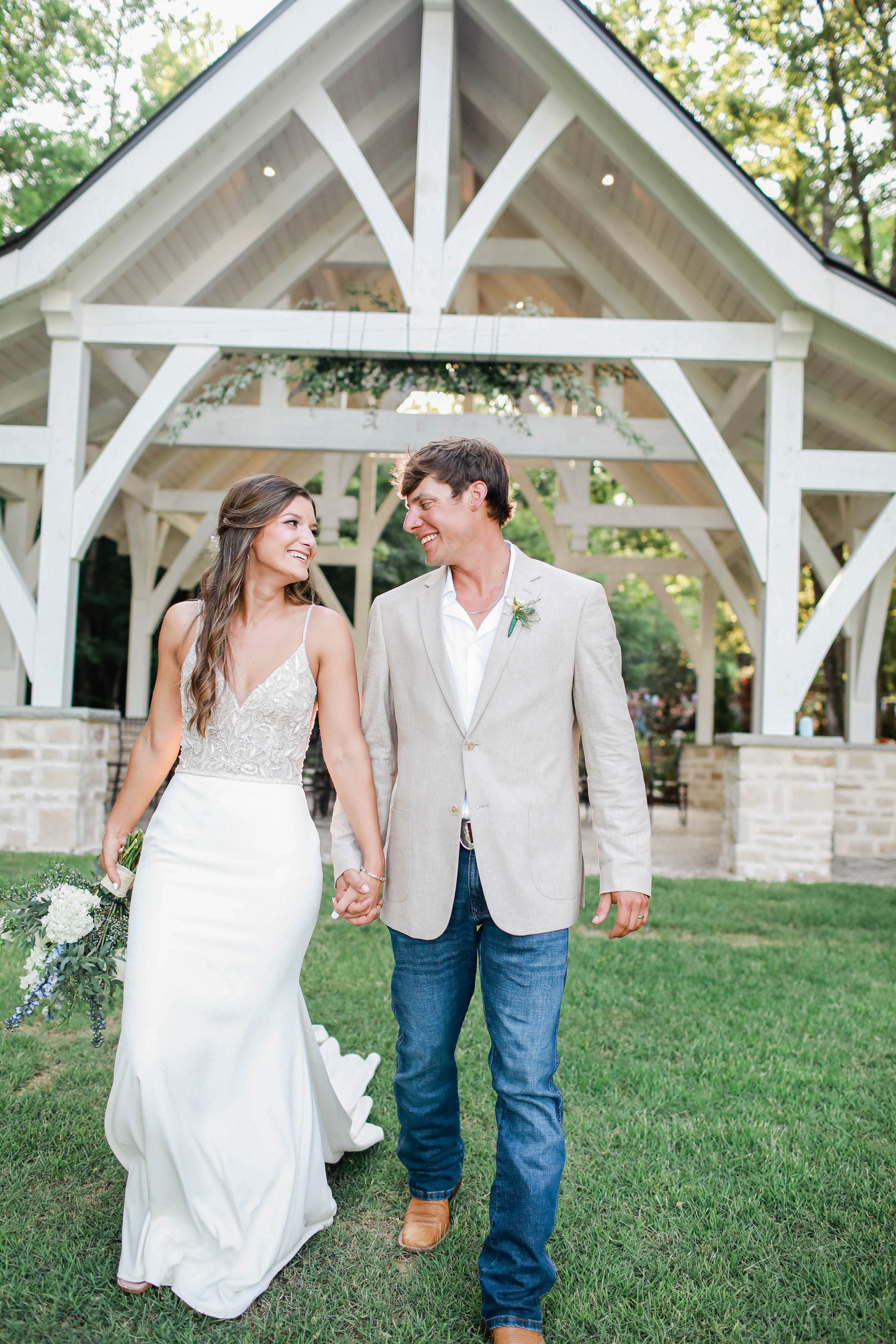 Couple laughing together during portraits at Brookwood Venue near Oxford, MS