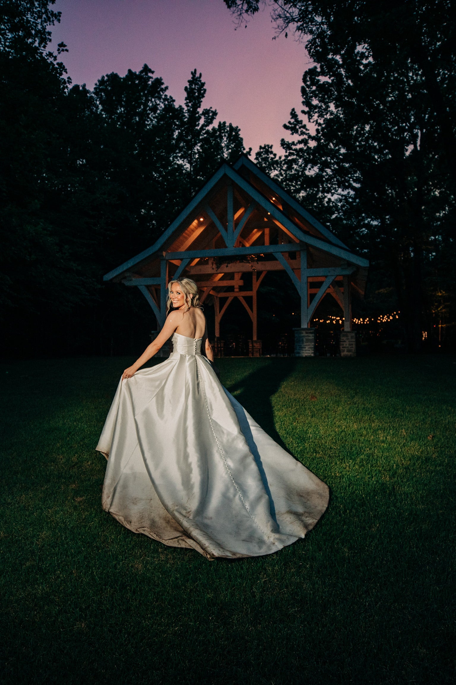 Bride walking through fields in wedding dress at Brookwood Venue in North Mississippi