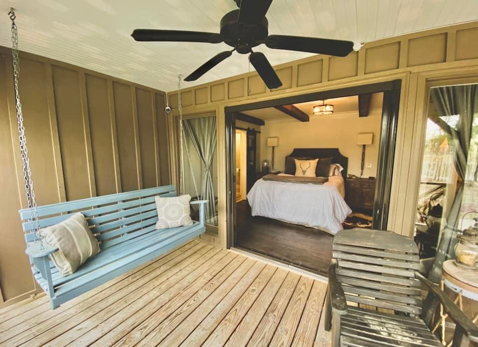 Spacious screened-in porch with rustic furniture at Brookwood Venue, Oxford, MS, for wedding prep