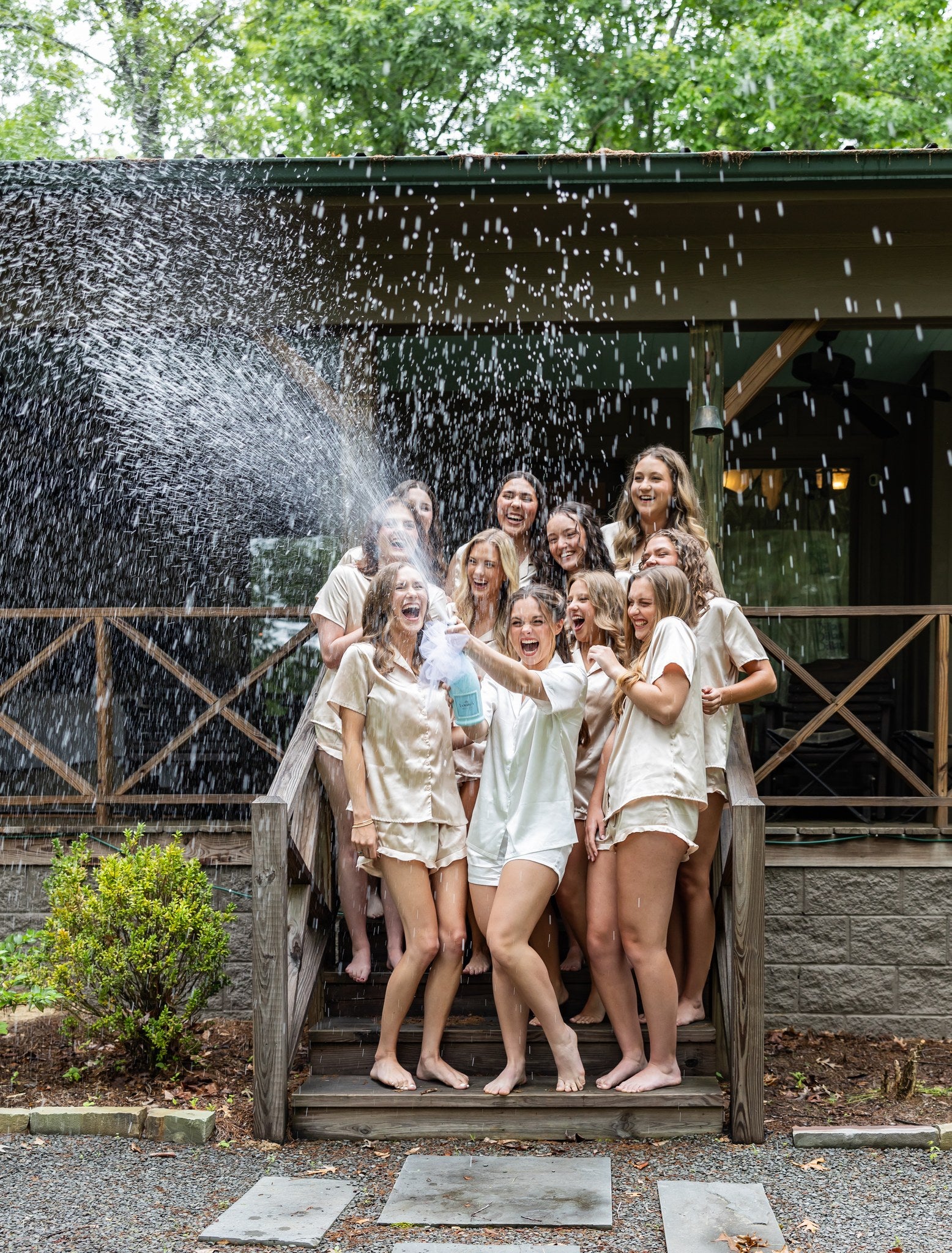 Bridesmaids clinking champagne glasses in Brookwood Venue bridal suite, North Mississippi