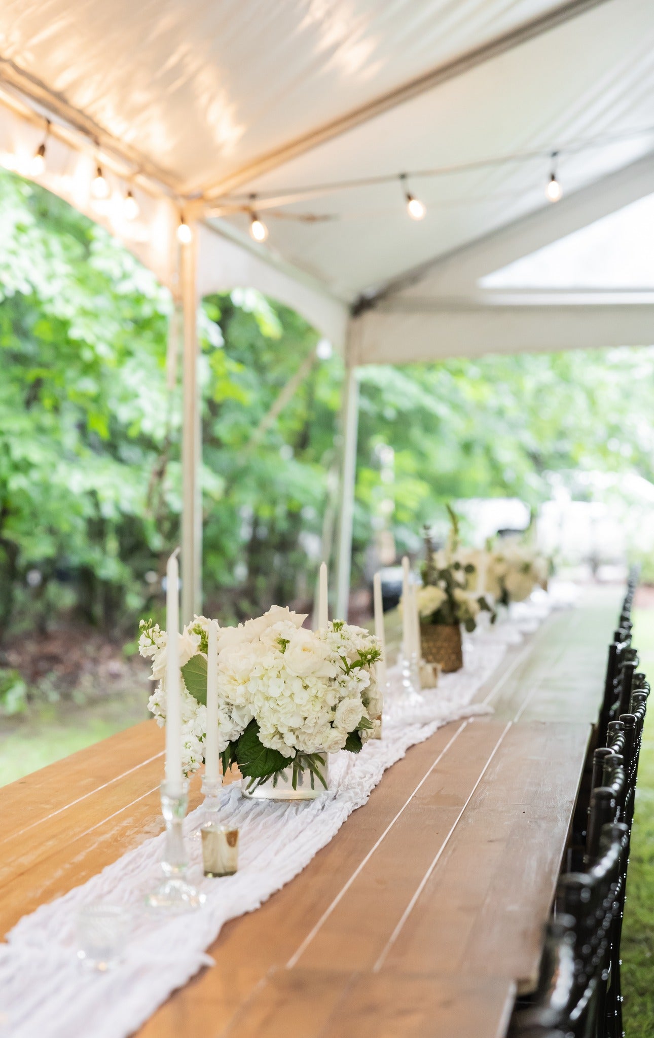 Reception tablescape with candles and greenery at Brookwood Venue