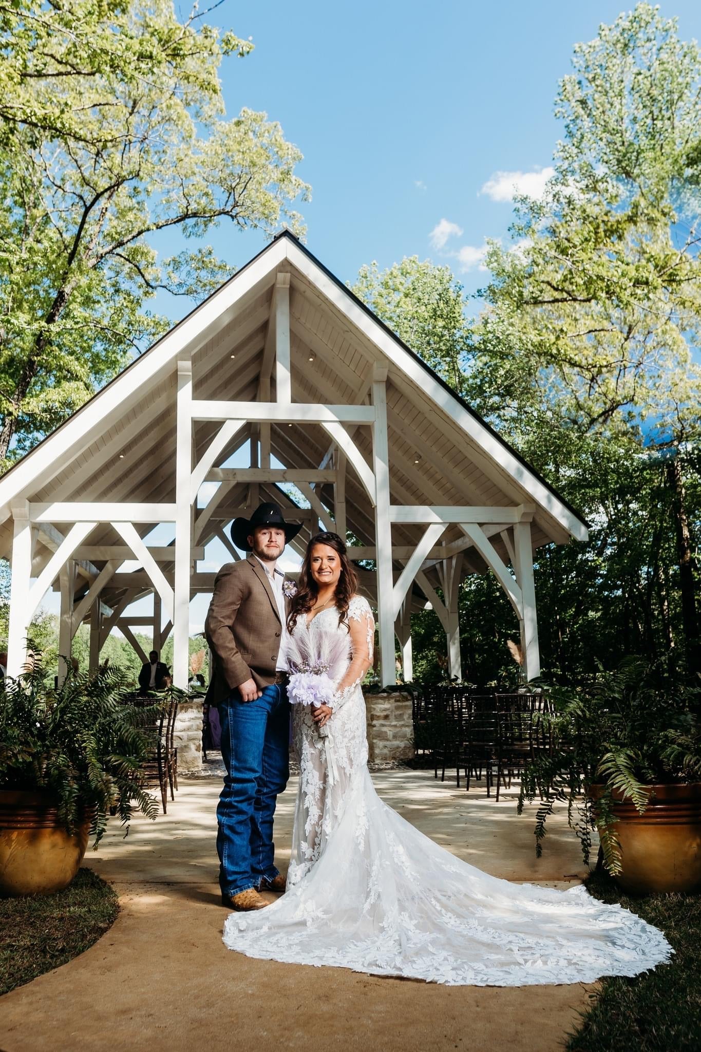 Newlyweds posing in front of chapel at Brookwood Venue in Bruce, Mississippi.