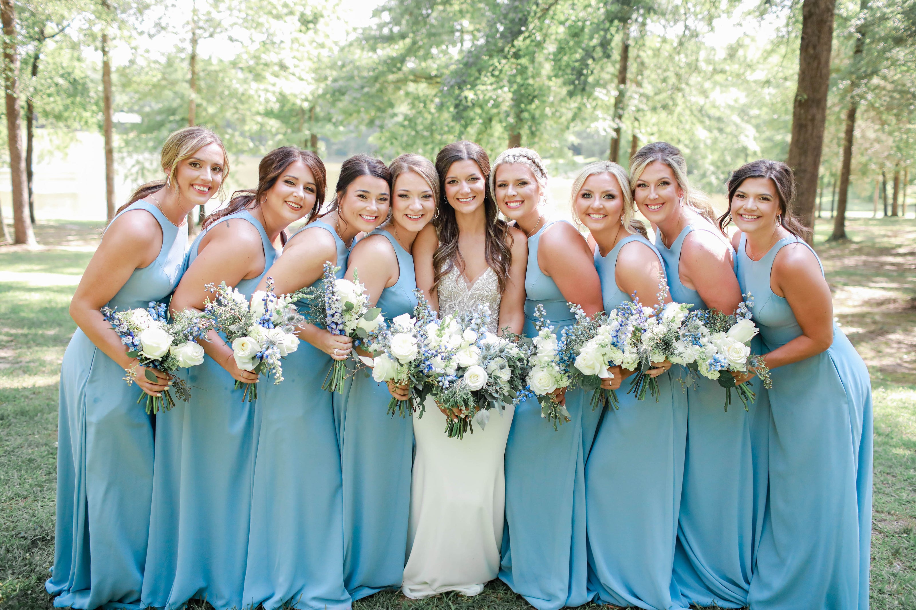 Bride and bridal party smiling in natural light during wedding photos in north mississippi
