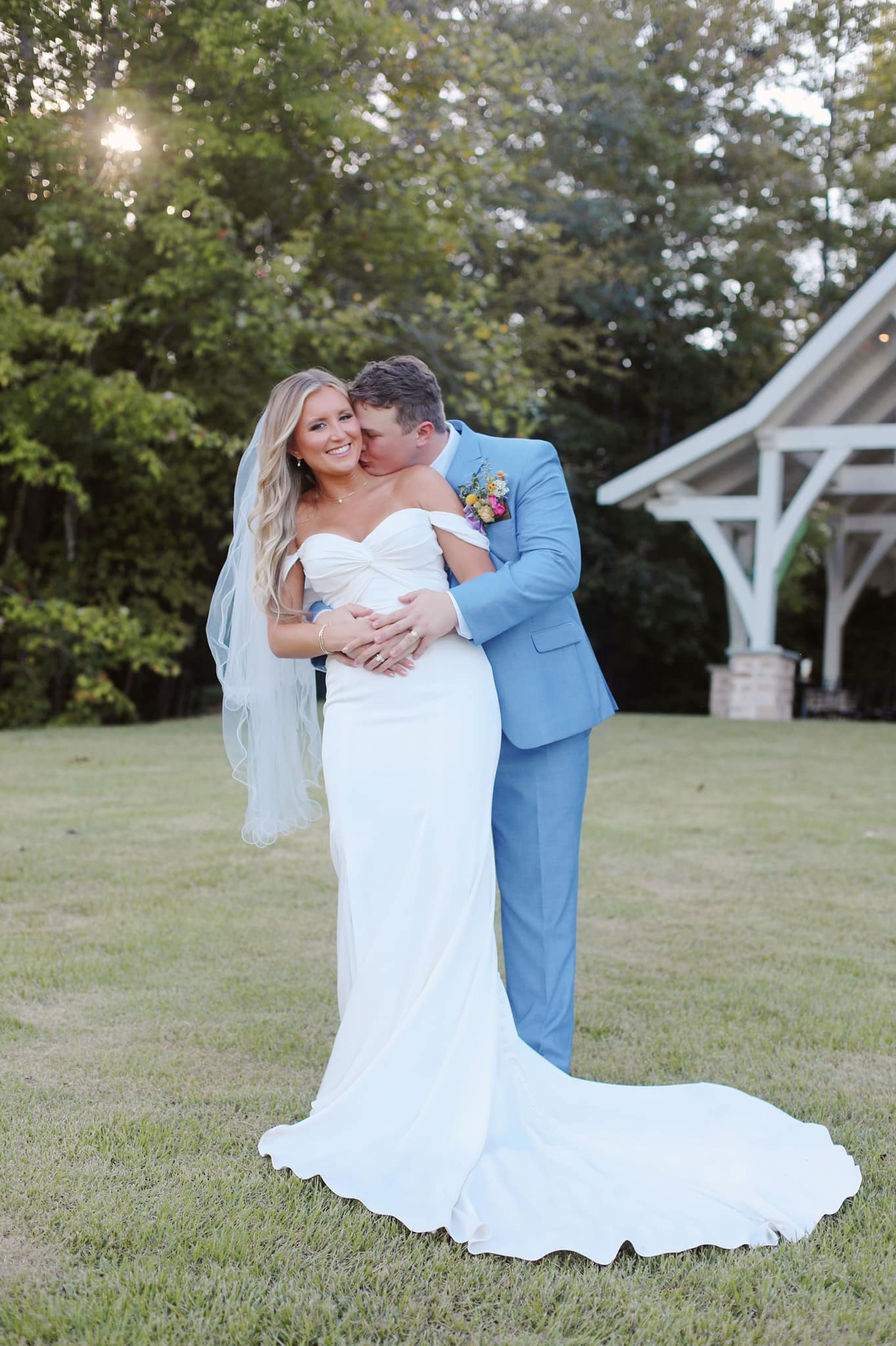 Romantic sunset portrait of bride and groom on Brookwood Venue dock, Oxford, MS