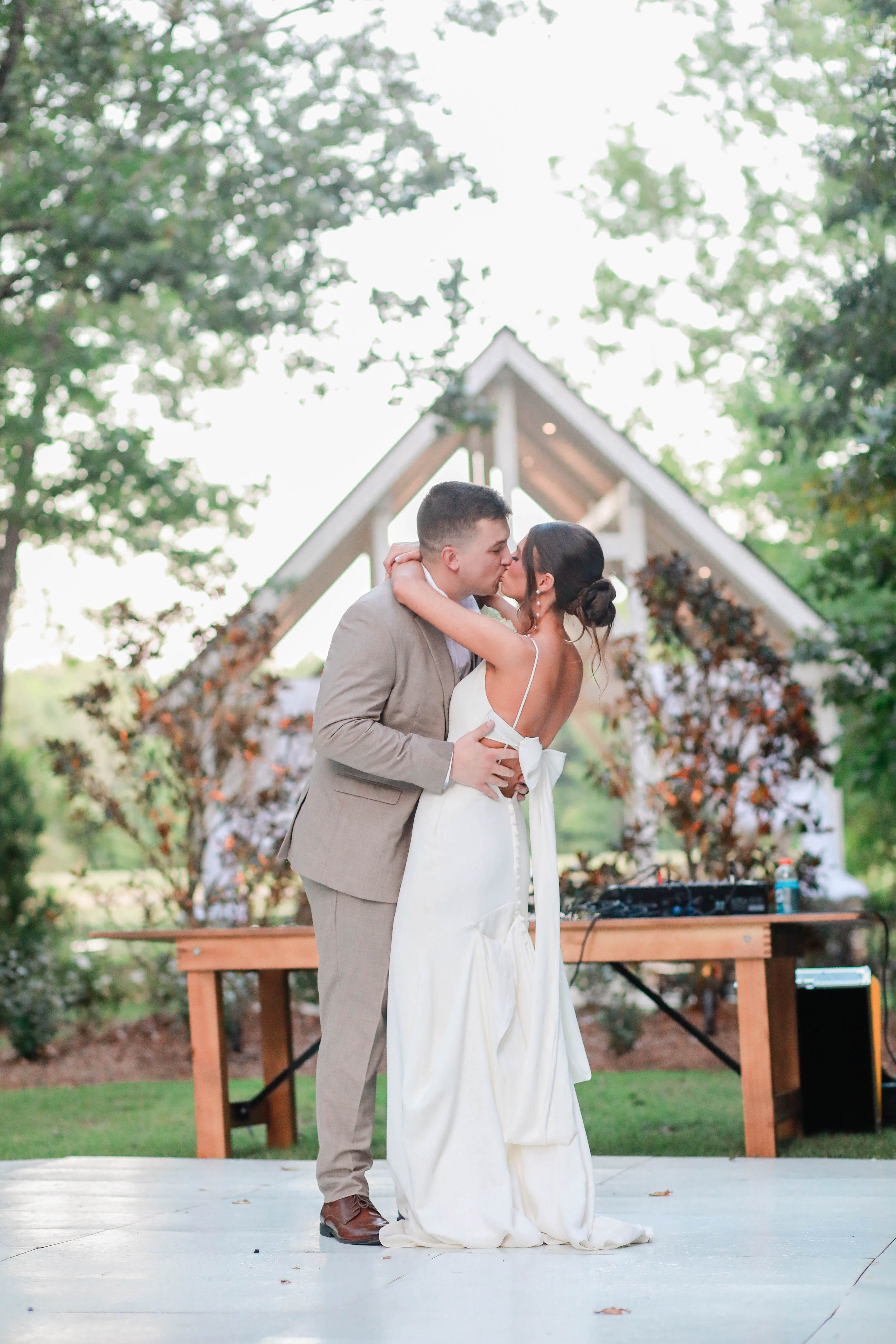 bride and groom kissing during first dance at wedding venue in bruce, mississippi