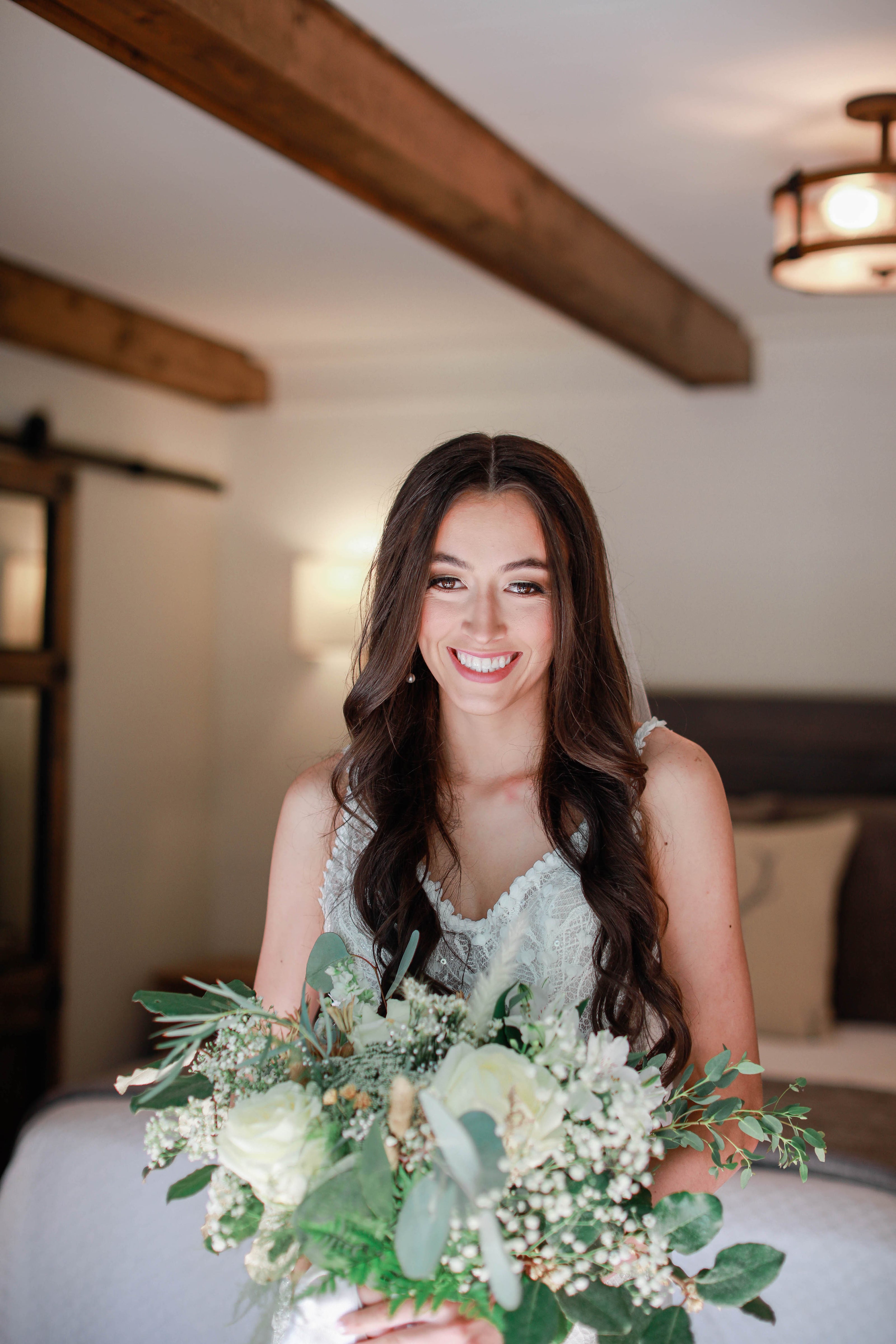 Bride smiling in natural light during wedding prep at Brookwood Venue.