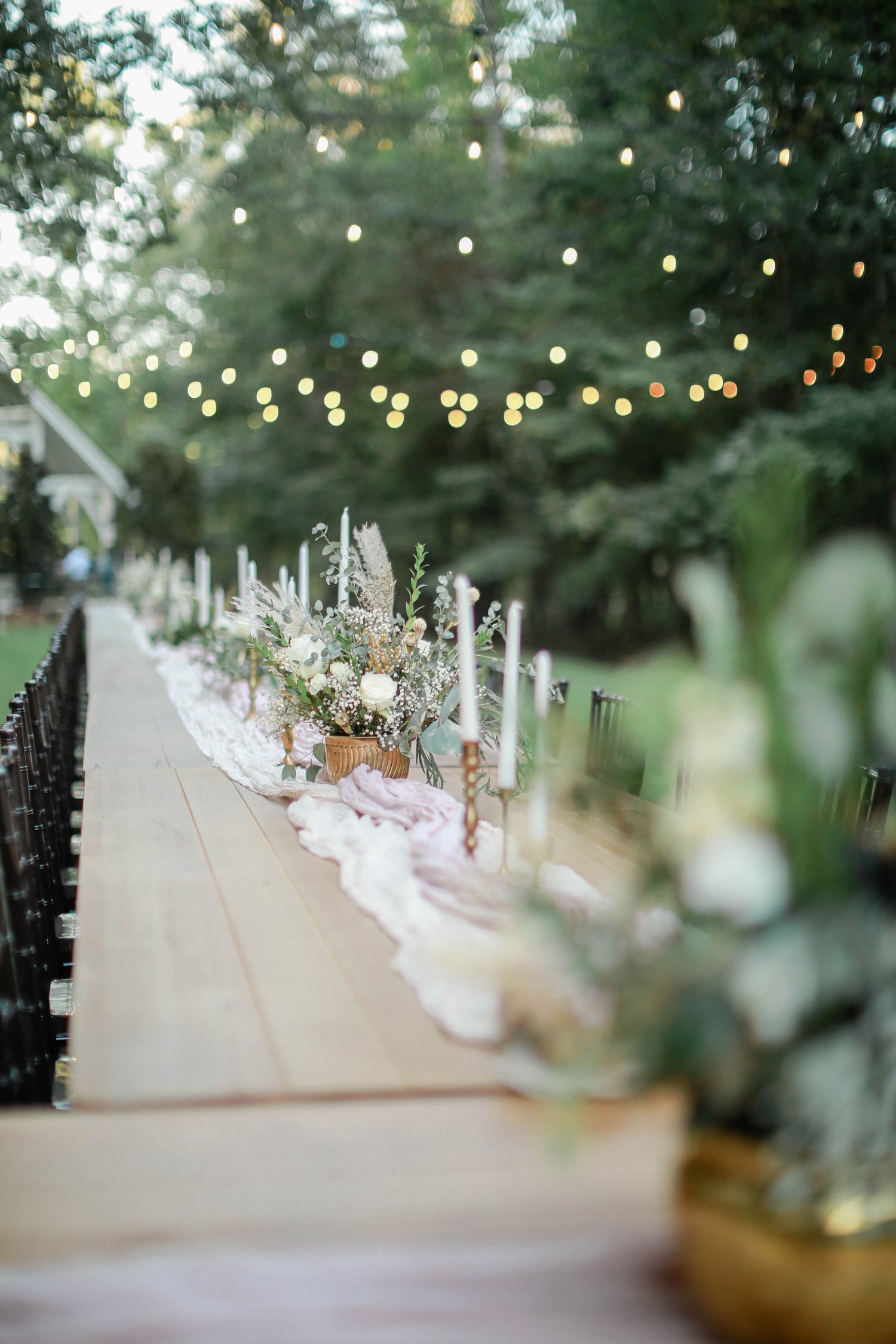 reception tables with floral centerpieces at Brookwood Venue, Bruce, Mississippi.