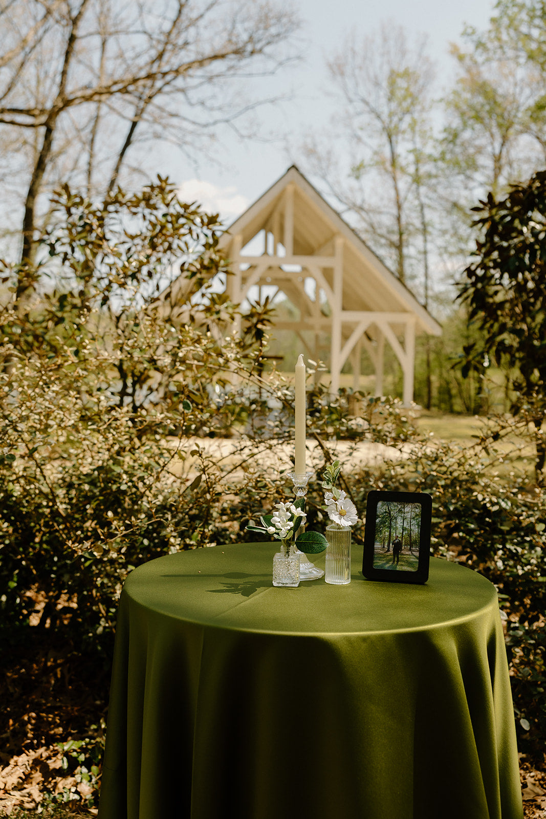 cocktail table with florals and candle decor with white chapel in the background 