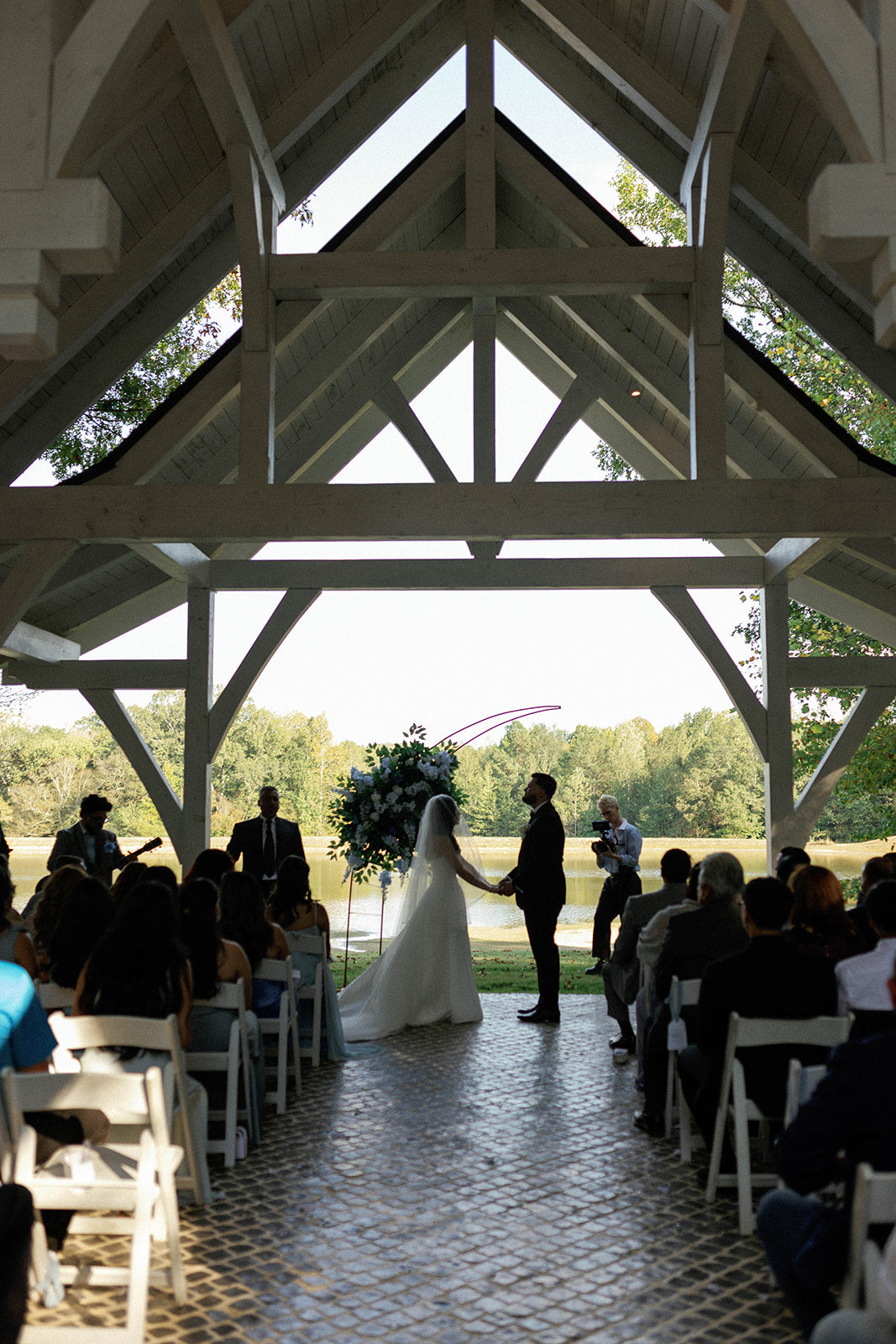 wedding ceremony under wooden chapel at countryside venue in bruce, mississippi